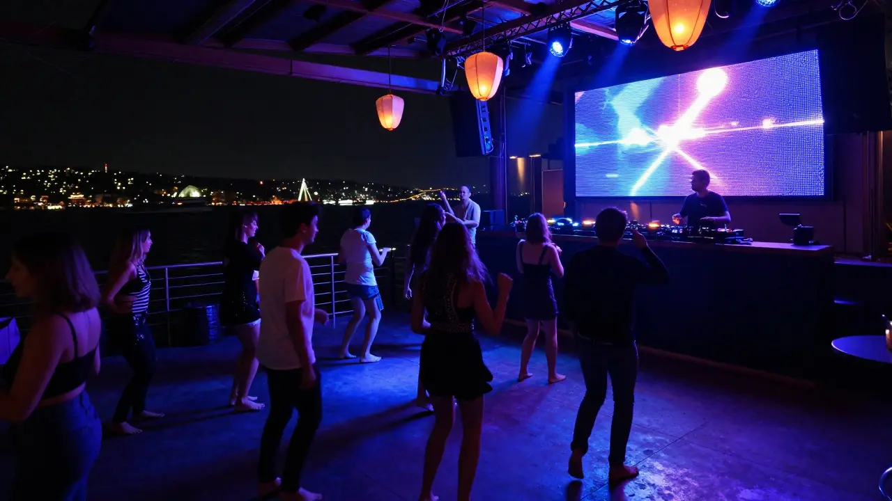 Crowd dancing on a yacht-turned-club under LED lights along the Bosphorus.